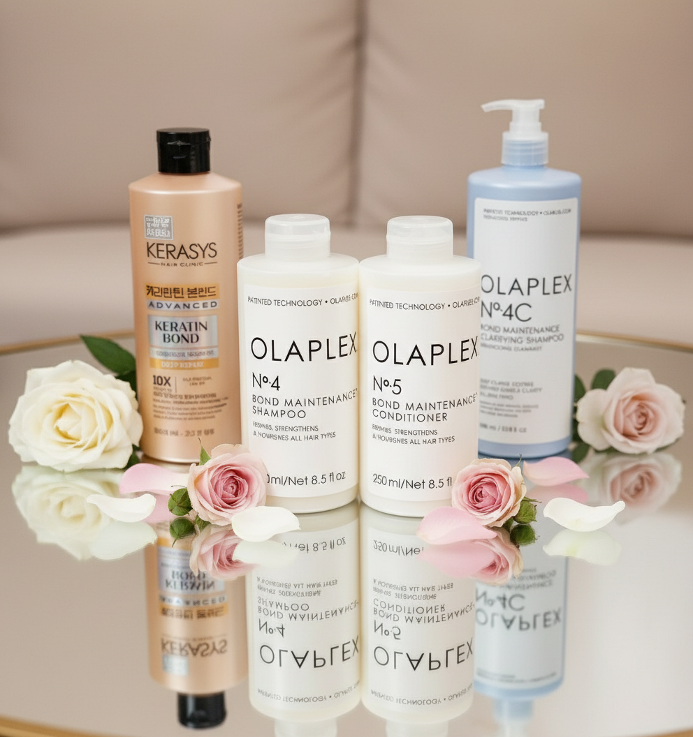 Olaplex and Kerasys shampoo and conditioner bottles on mirrored vanity table with roses in bright luxurious spa setting