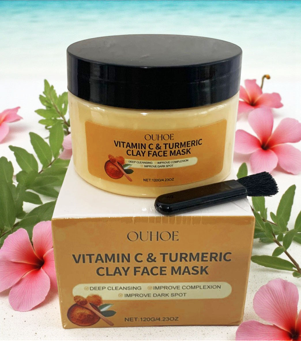 OUHOE Vitamin C & Turmeric Clay Face Mask with packaging and brush on a floral background