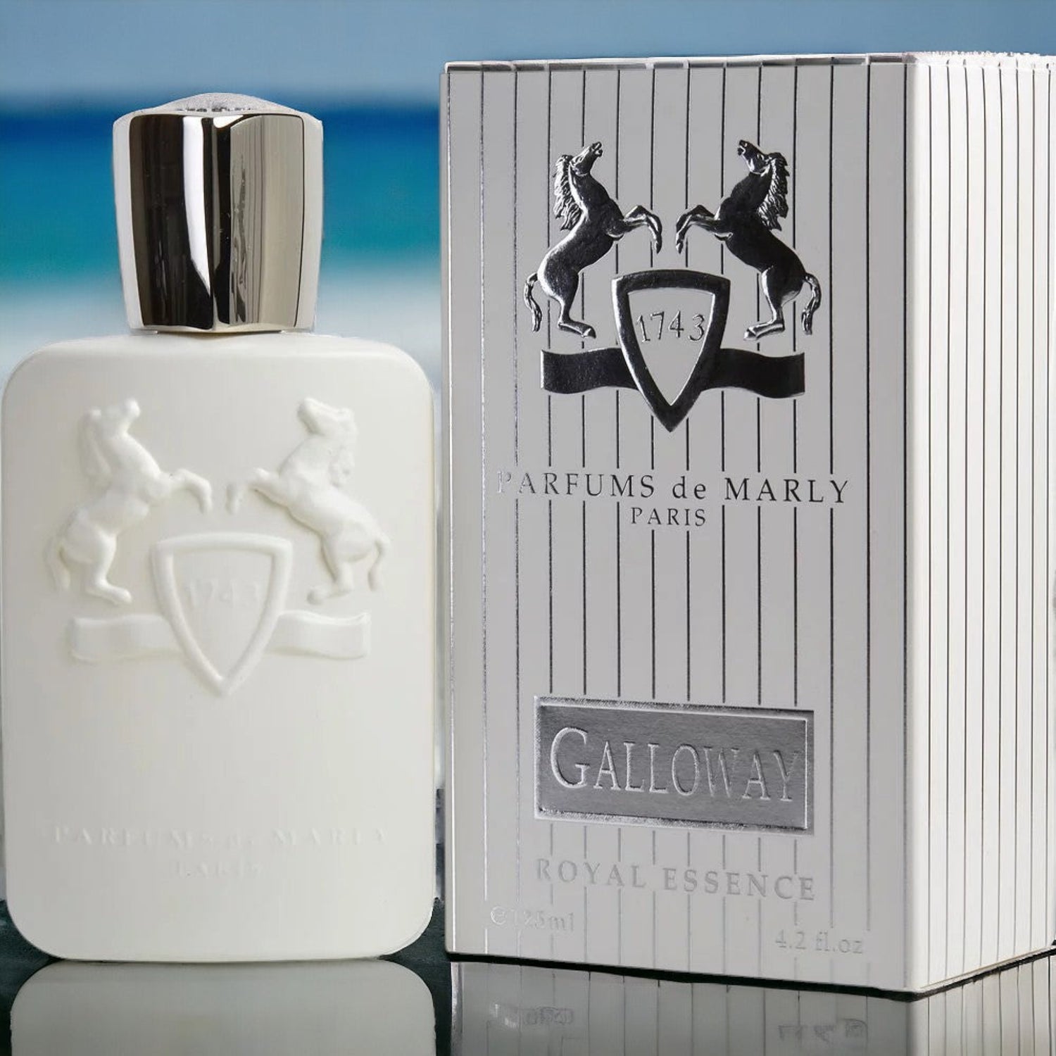Parfums de Marly Galloway perfume bottle and packaging on a reflective surface with a blurred blue background