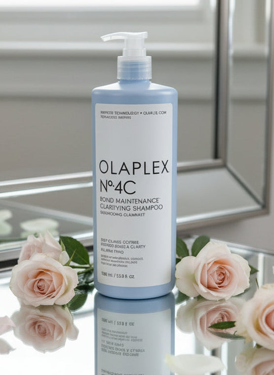 Olaplex No.4C shampoo bottle with roses on a reflective surface