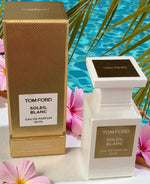 Tom Ford Soleil Blanc perfume bottle and packaging with a pool and flowers in the background