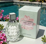Jimmy Choo floral eau de toilette with packaging by a poolside