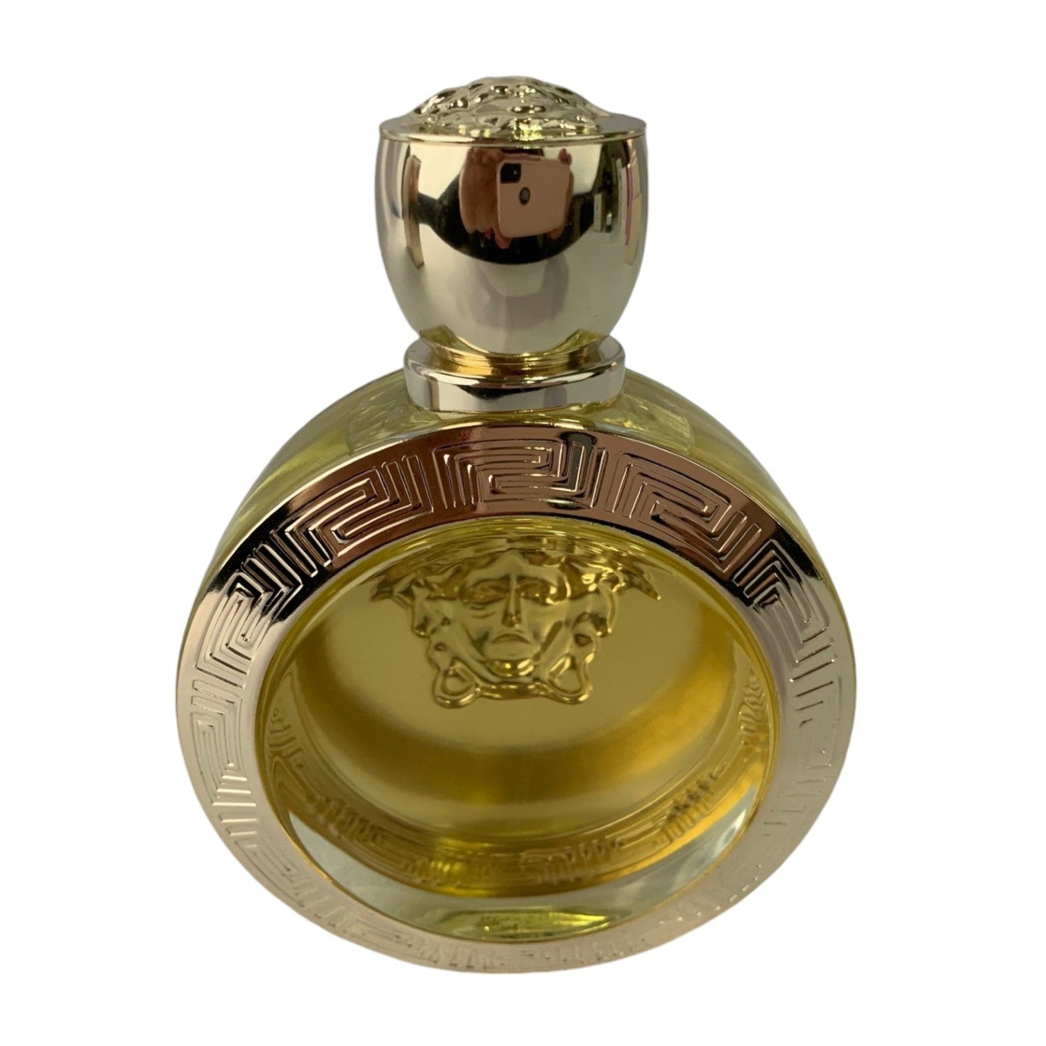 Gold perfume bottle with intricate design on a white background