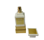 Tom Ford perfume bottle with gold cap and packaging on a white background