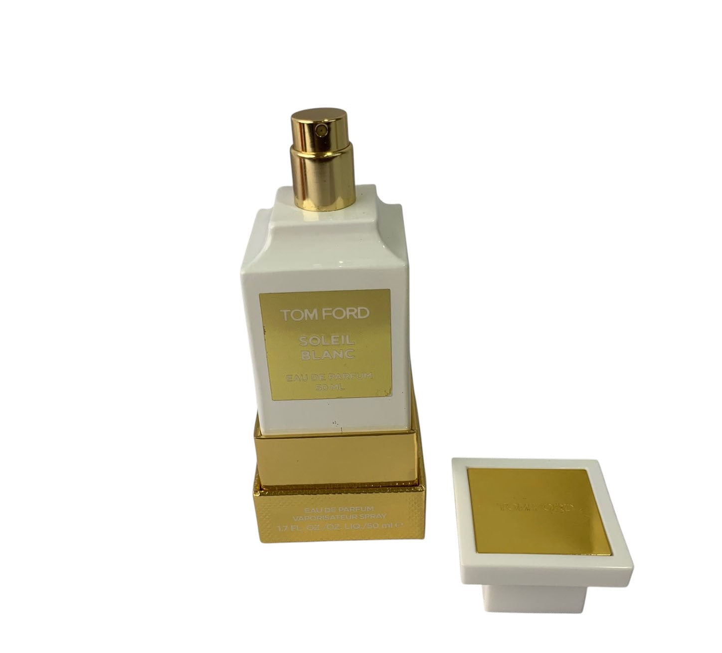 Tom Ford perfume bottle with gold cap and packaging on a white background