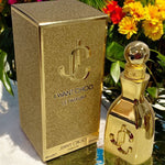 Gold Jimmy Choo perfume bottle and packaging with flowers in the background